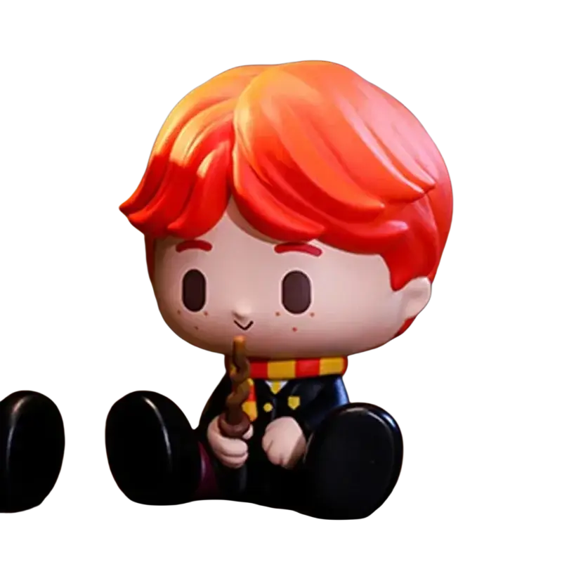 A pop mart harry potter blind box figurine of a young boy with red hair in a black robe holding a wand actual product