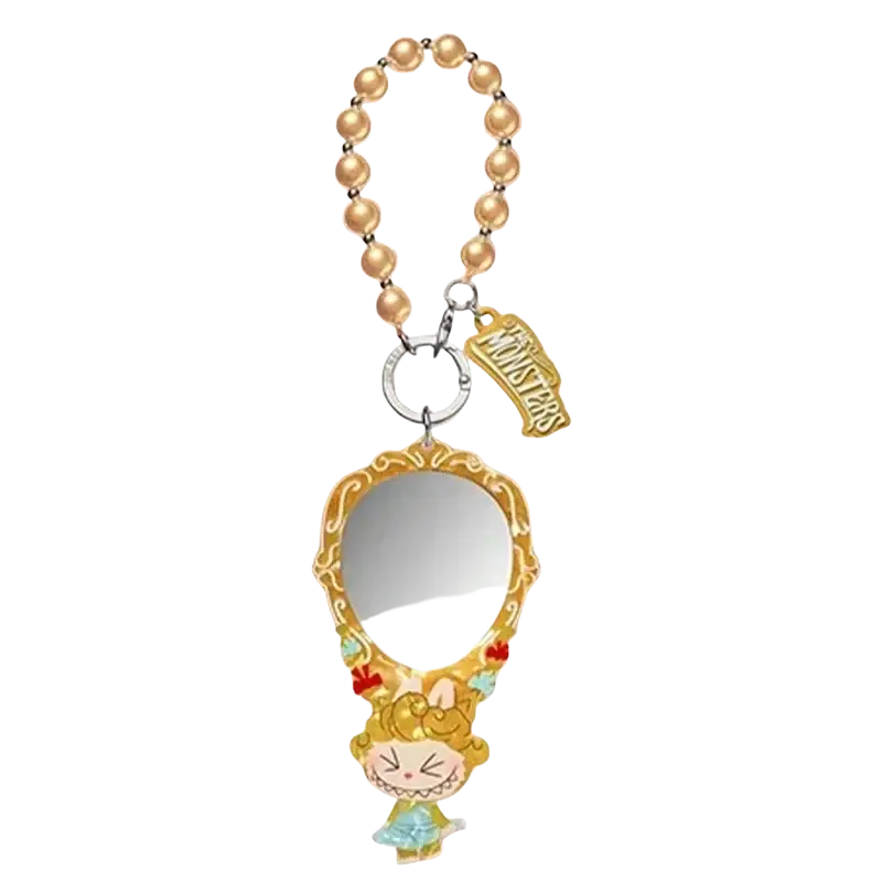 A gold-toned ornate mirror charm with a pearl beaded strap and monsters tag from pop mart guess bag