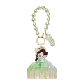 A mint-green translucent acrylic comb-shaped keychain featuring a cartoon character from pop mart guess bag