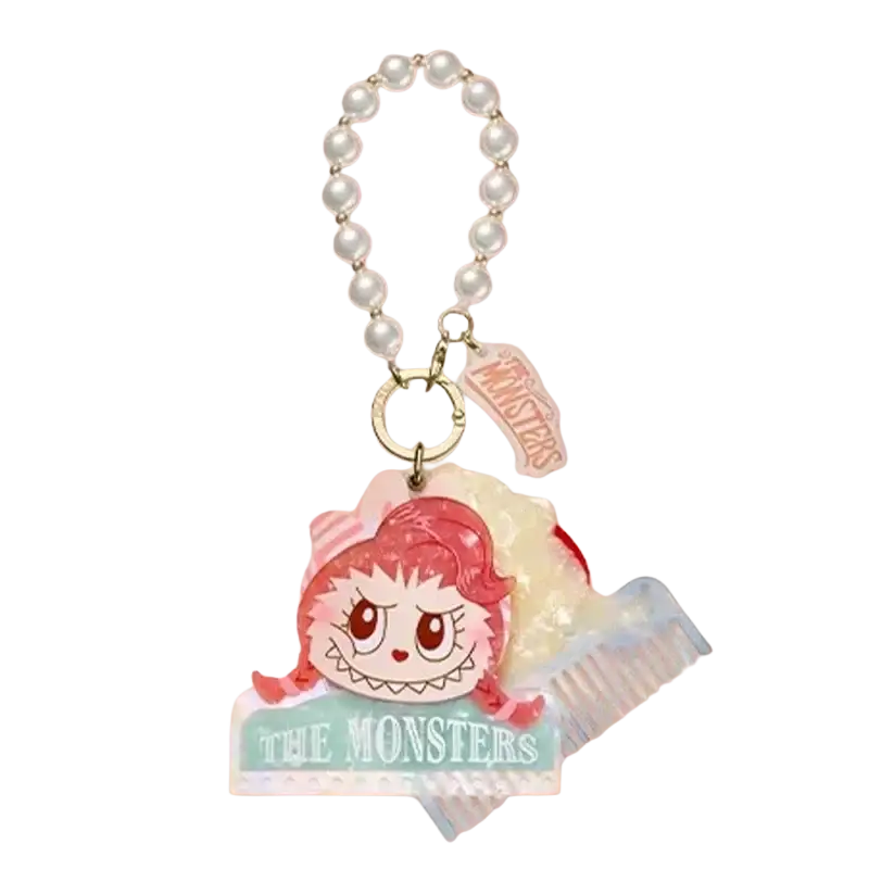 A pink-haired cartoon monster charm with pearl chain and comb accessory on acrylic base from pop mart guess bag