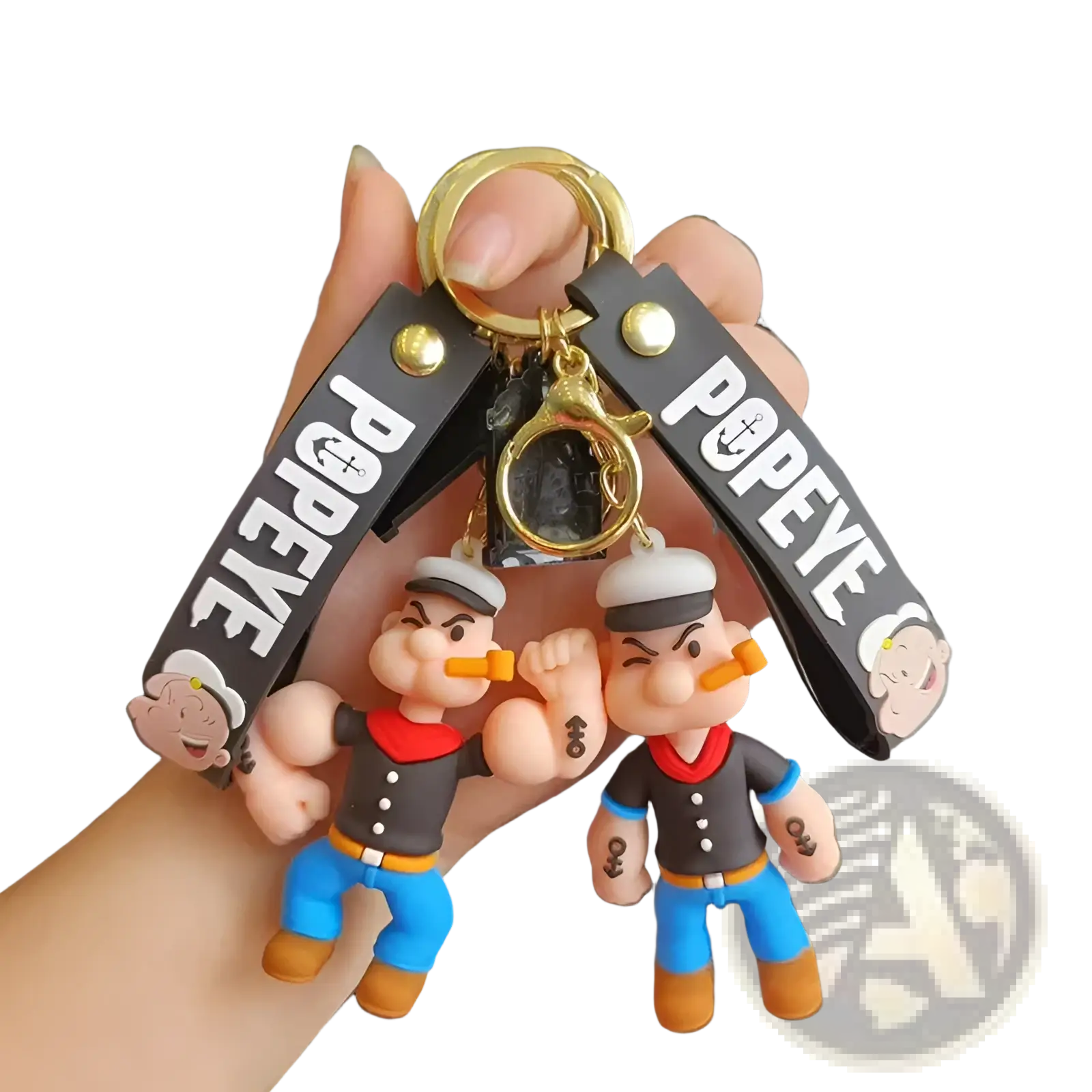 A gold-toned popeye silicone keychain with two black and blue figurines on black popeye printed straps