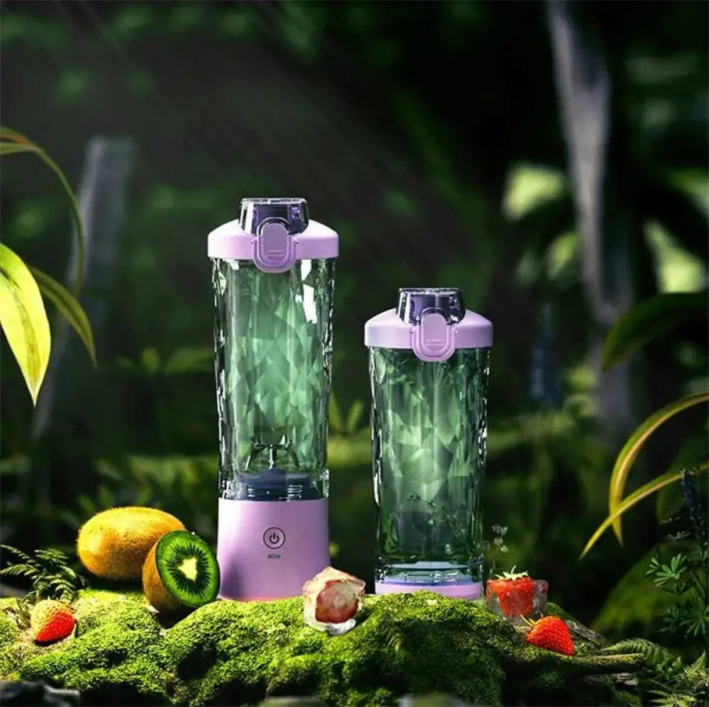 Two purple and green arbaglobal portable 6-blade personal smoothie blenders with faceted glass bodies, one larger than the other