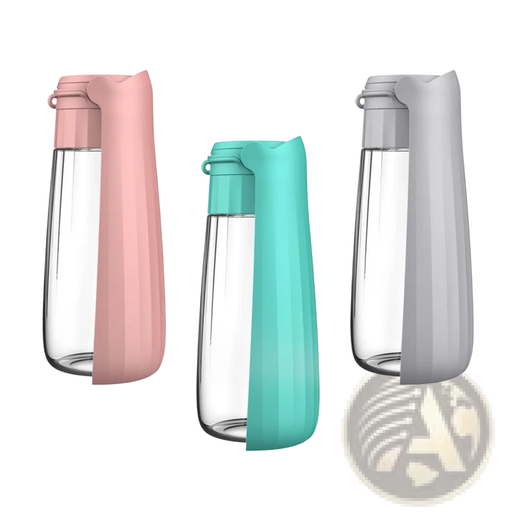 Three portable dog water bottles with 550ml clear glass bodies and soft silicone sleeves in pink teal and gray