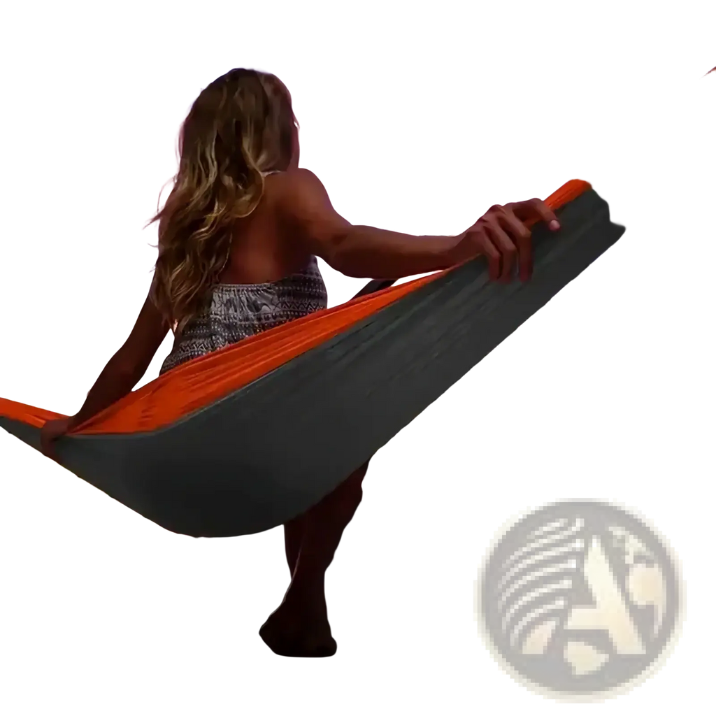 Portable double camping hammock in orange and gray suspended between railings for outdoor relaxation