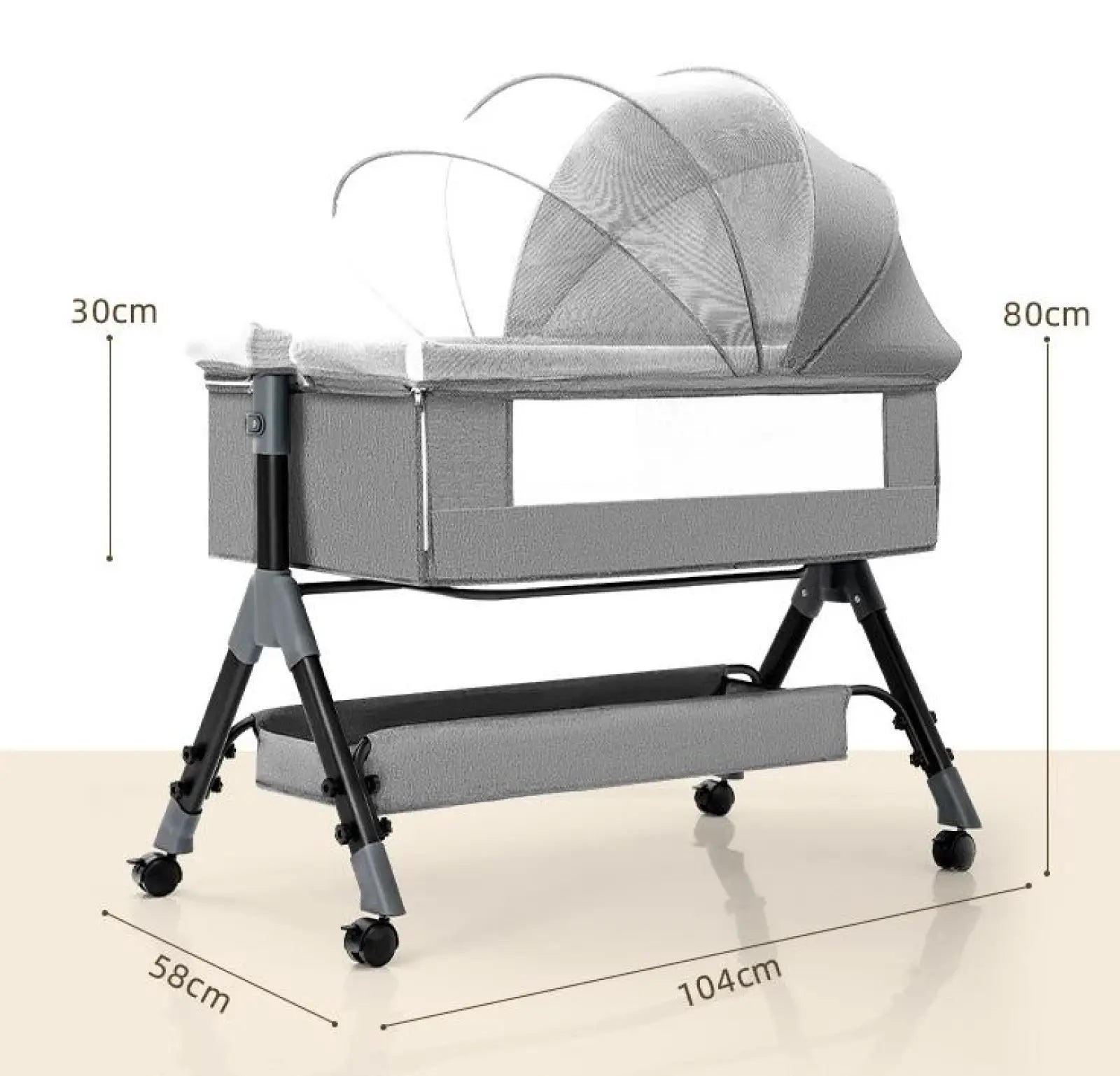 Portable folding baby crib in gray fabric with mesh canopy, black metal frame, mattress, and wheels for mobility