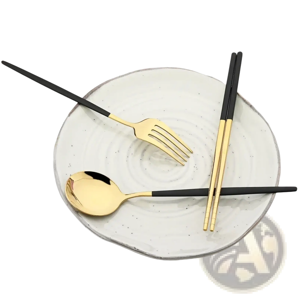 Gold and black stainless steel portable cutlery set with fork spoon and chopsticks on white ceramic plate