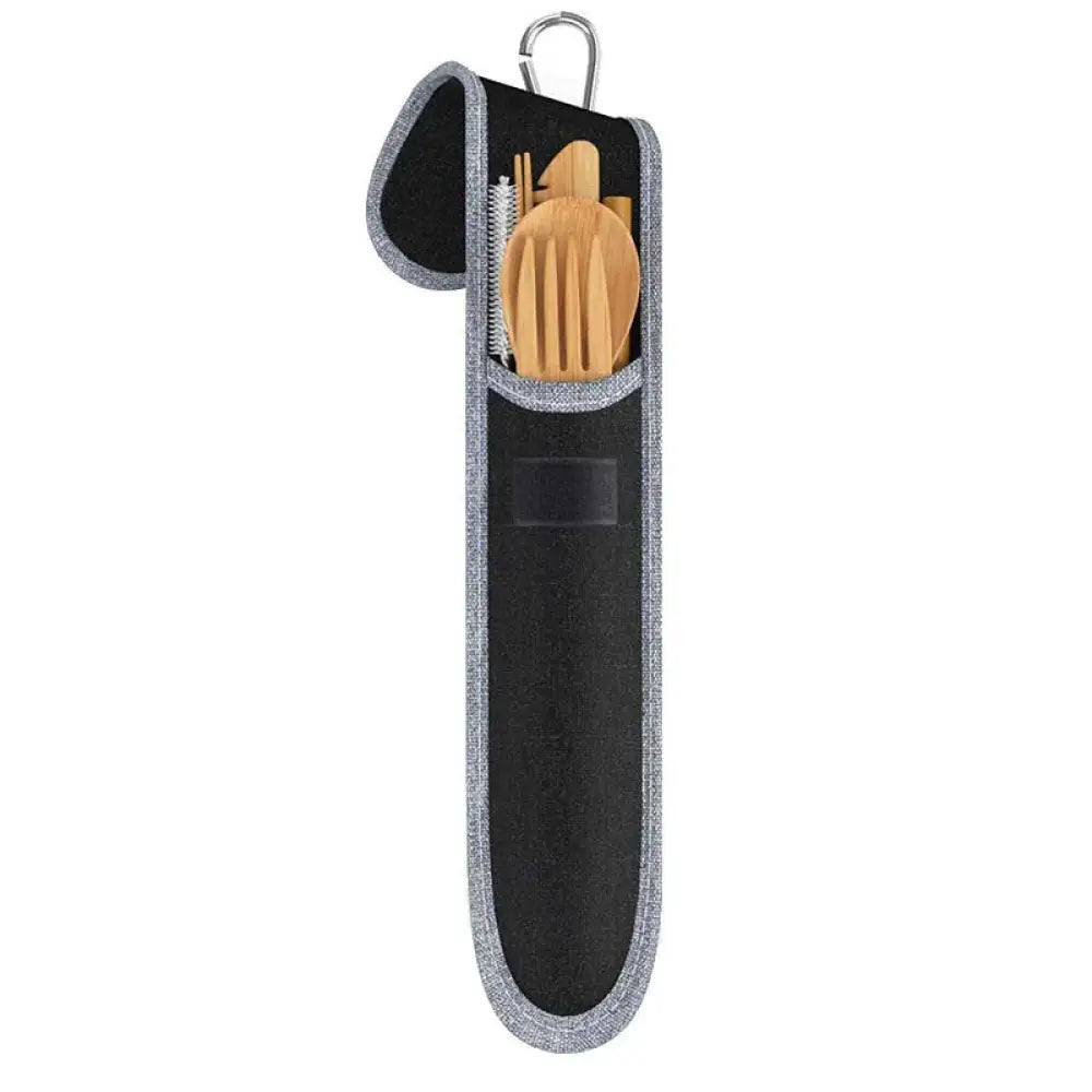 Black and gray fabric carrying case with silver carabiner holding sustainable bamboo and stainless steel travel cutlery set