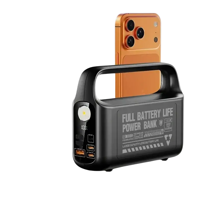 Black power bank 50000mah with built-in cable and orange smartphone inserted in top slot for portable power outdoors