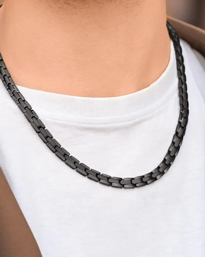 Black titanium magnetic therapy necklace with interlocking rectangular links and neodymium magnets