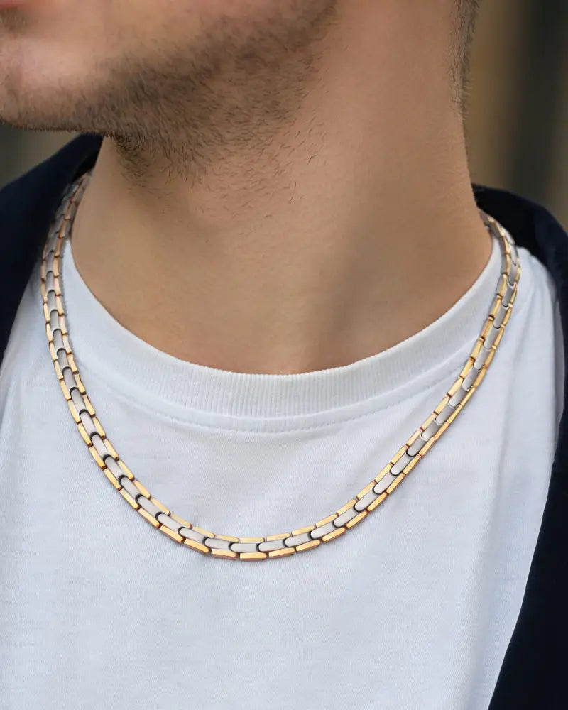 Two-tone titanium magnetic therapy link necklace featuring a gold and silver interlocking chain design