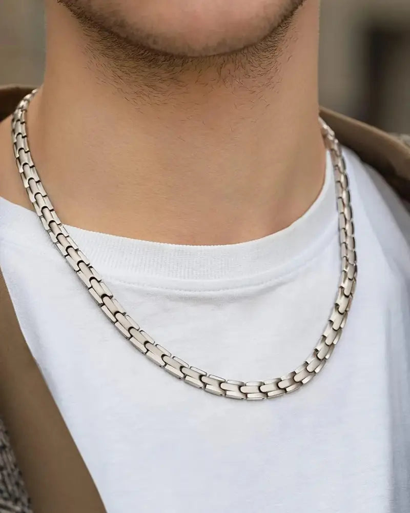 Silver titanium magnetic therapy necklace with 55 magnets featuring a silver-toned interlocking link chain worn around the neck