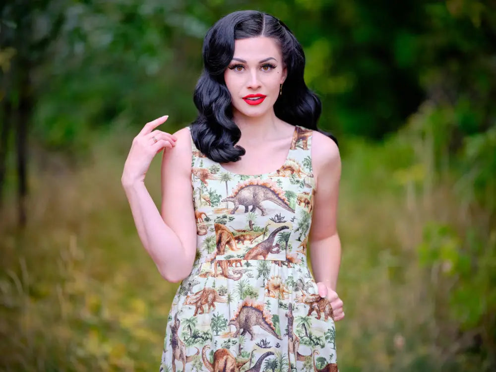 Vintage prehistoric dinosaur print sleeveless a-line dress in cream cotton with detailed dinosaur and plant motifs
