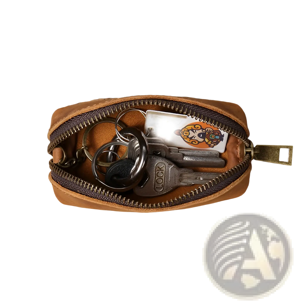 Premium cowhide leather tan key pouch with dark brown zipper and brass pull containing keys and an illustrated card