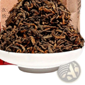A white ceramic bowl filled with dark brown twisted loose-leaf premium Yunnan ripe puer tea 500g health care cake