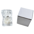 A clear faceted crystal gift box containing a preserved white rose for an eternal flower display