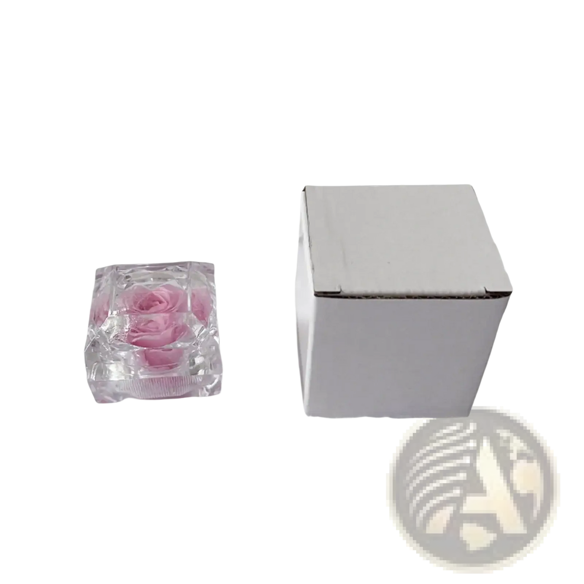 A clear faceted glass cube containing a preserved pink rose in a preserved rose crystal gift box eternal flower