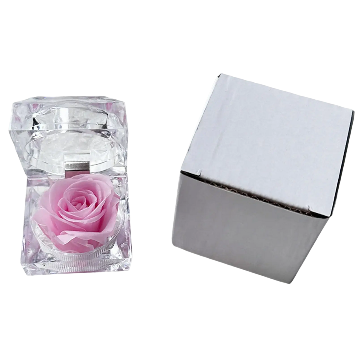 A delicate pink preserved rose displayed inside a clear faceted crystal gift box eternal flower