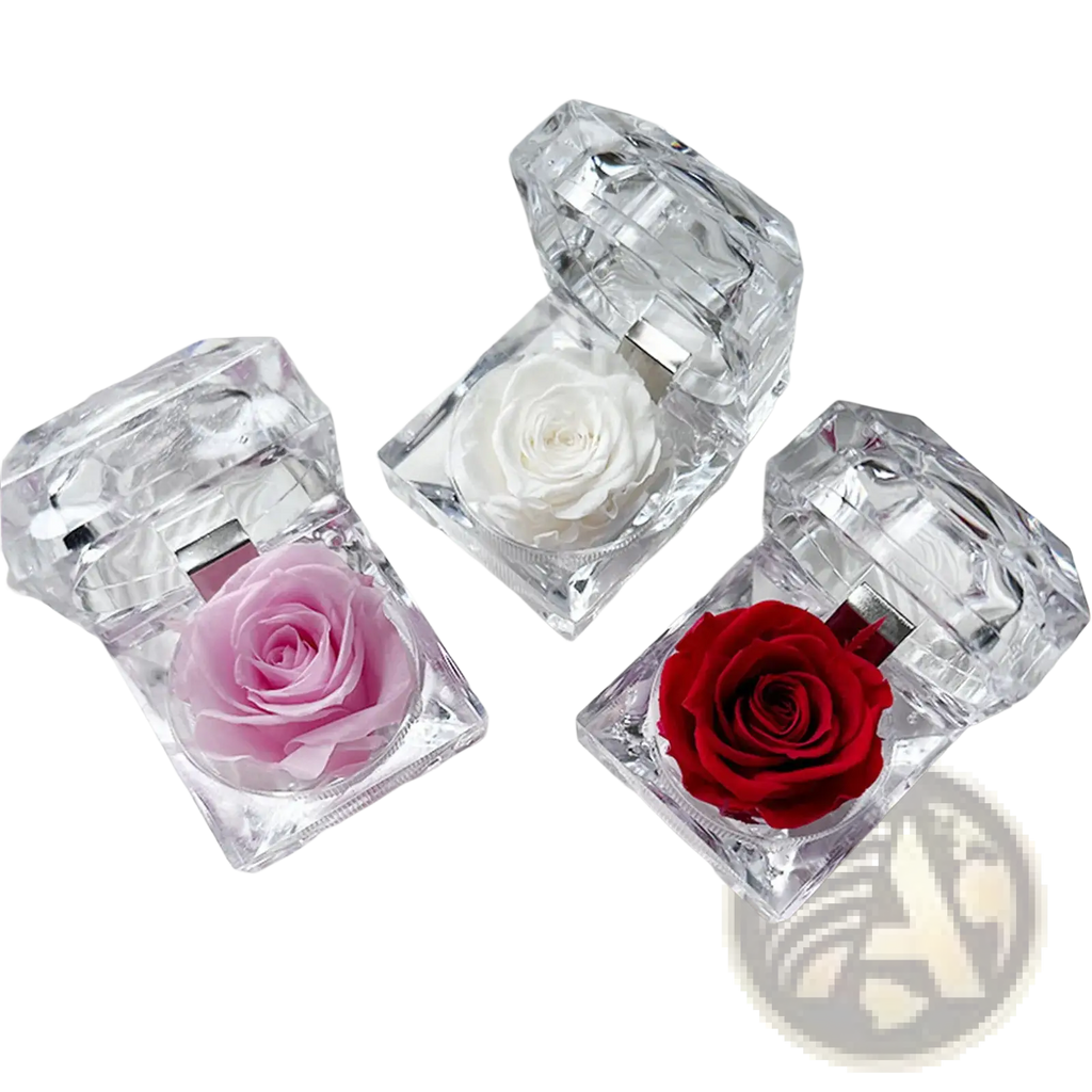 Three crystal-clear faceted diamond-shaped preserved rose crystal gift boxes with pink white and red roses inside