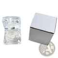 A clear faceted crystal gift box containing a preserved white rose for an eternal flower display