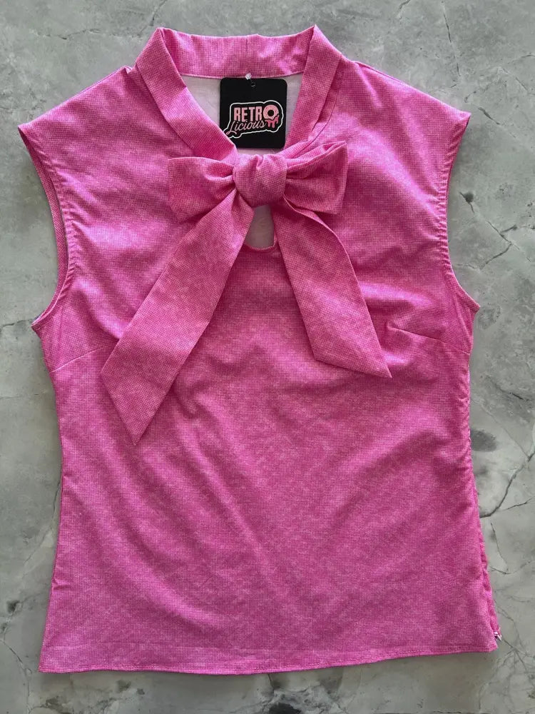 A vibrant pink cotton sleeveless top with textured fabric and bow neckline featuring retro liquids brand tag