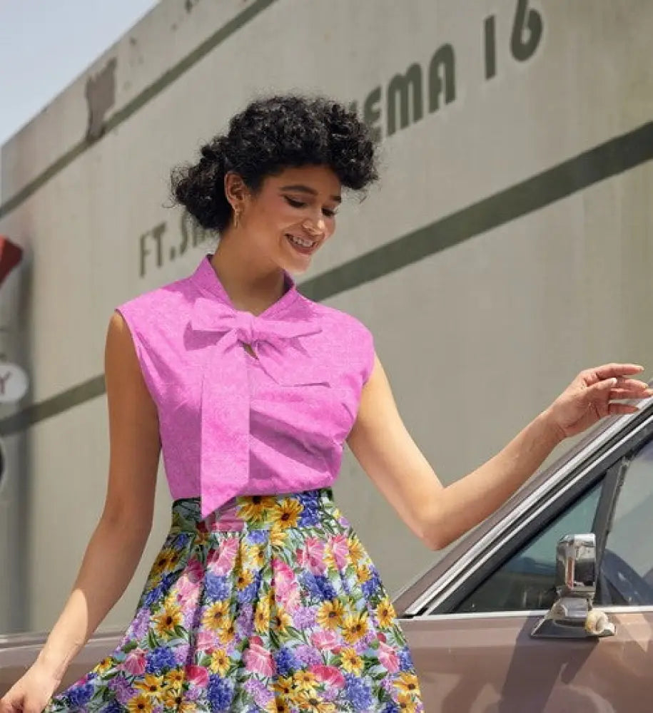 Vibrant pink cotton sleeveless blouse with a prominent bow at the neckline retro pink mosaic cotton bow top