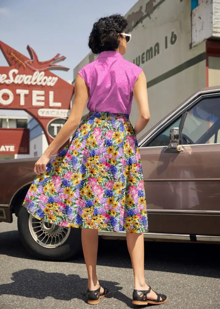 Retro pink mosaic cotton bow top featuring a vibrant full skirt with yellow pink and blue floral pattern on light background
