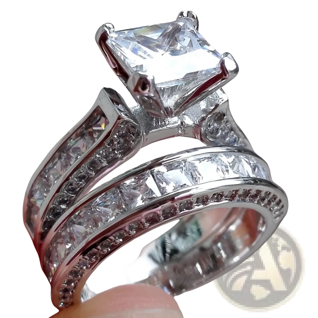 A sparkling silver couple anniversary ring set featuring a princess cut cz center stone with channel and pavé diamonds