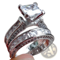 A sparkling silver couple anniversary ring set featuring a princess cut cz center stone with channel and pavé diamonds
