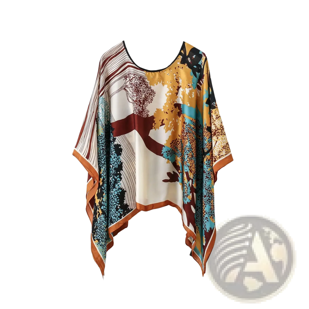 Printed silk patterned pullover shawl cape with vibrant autumnal tree print in gold teal and maroon on off-white background