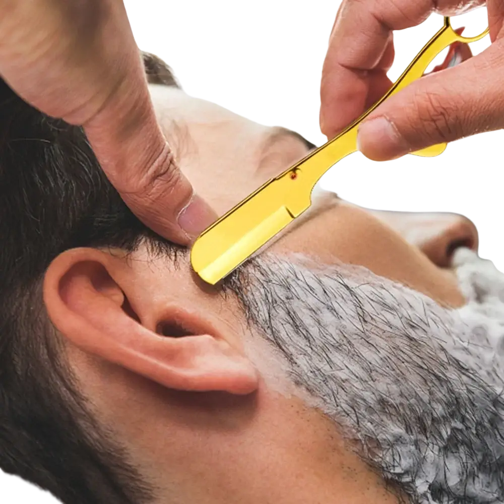 Gold-colored professional ring handle straight edge razor with polished metallic finish and classic curved blade design