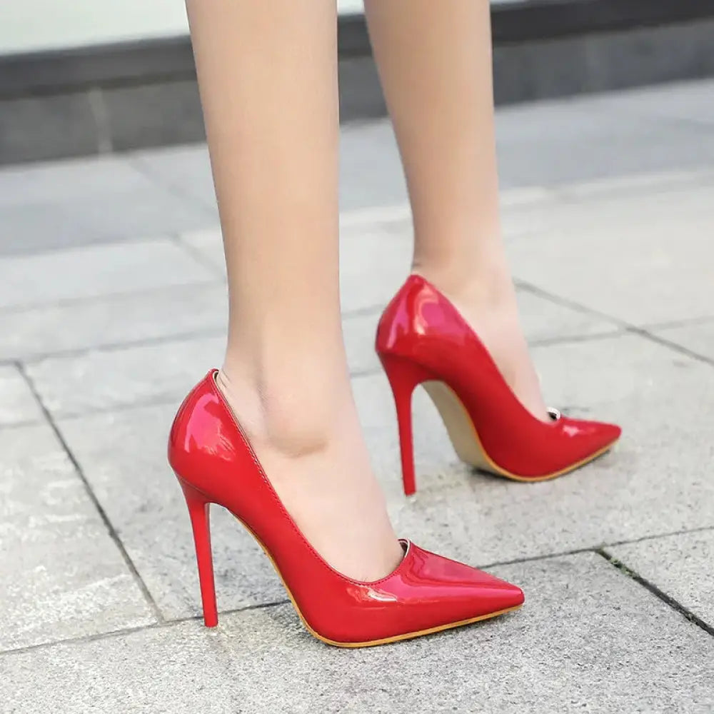 Red patent leather pointed toe stiletto pumps with slender heels for elegant formal wear