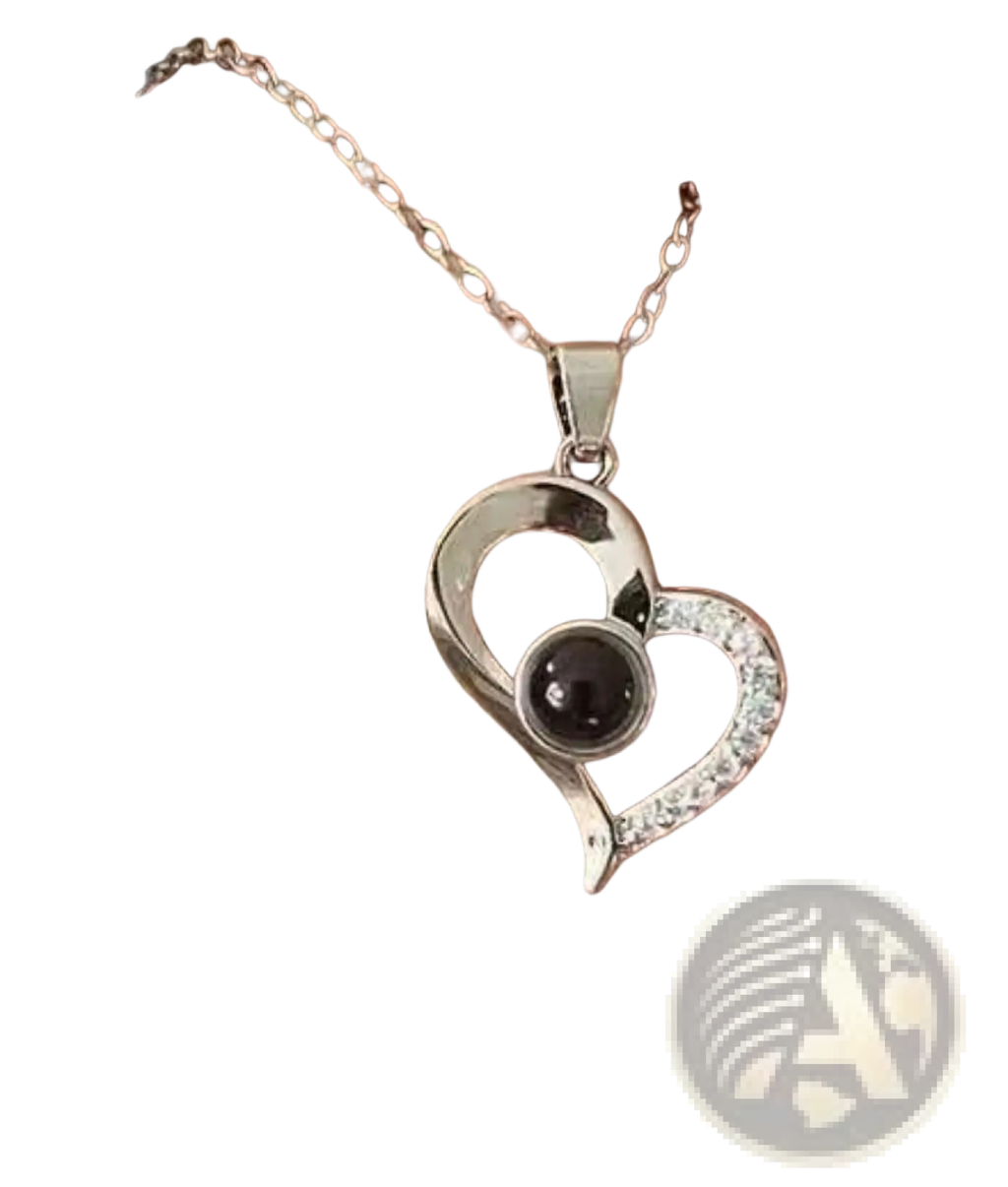 Silver projection heart necklace with black spherical centerpiece and clear stones on delicate chain with rose gift box