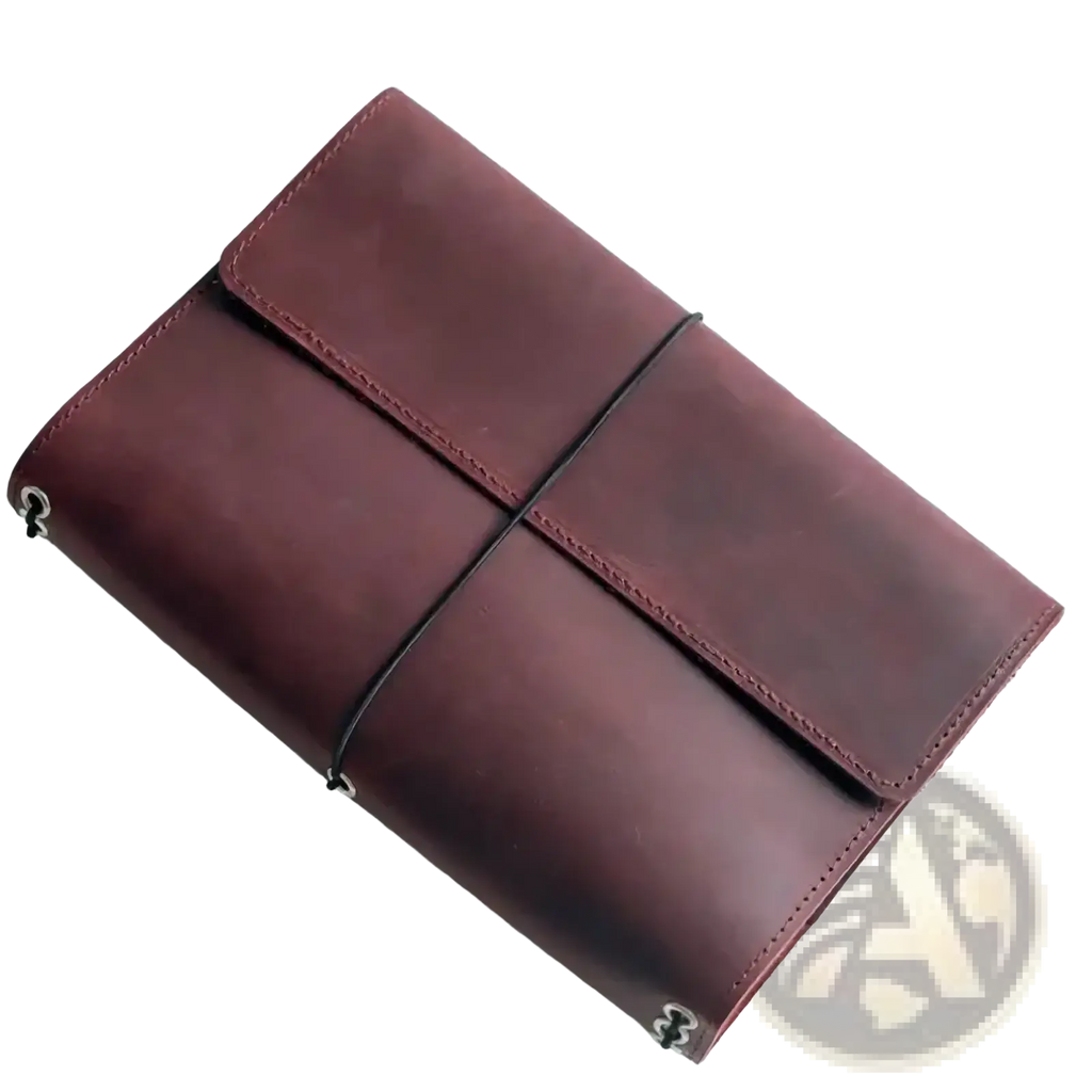A rich burgundy PU leather refillable travel journal cover planner with minimalist design and black elastic band closure