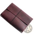 A rich burgundy PU leather refillable travel journal cover planner with minimalist design and black elastic band closure