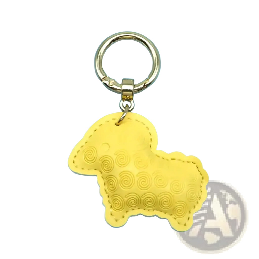 Yellow pu leather sheep keychain with stitched details and gold-tone metal ring used as a bag charm