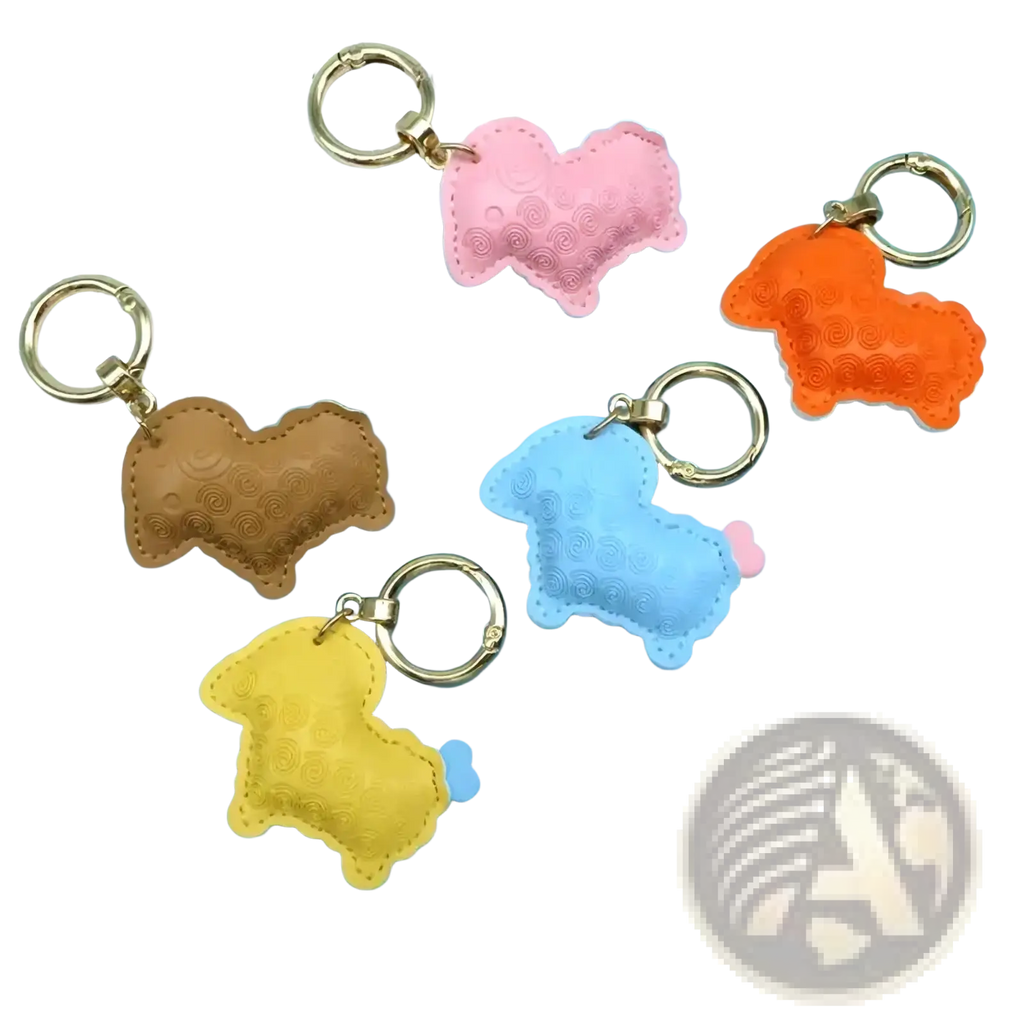 Pastel-colored pu leather sheep keychain bag charms with textured surfaces and gold-toned metal rings
