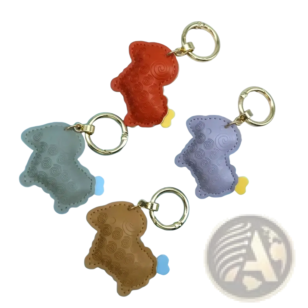 A set of four colorful pu leather sheep keychain bag charms embossed with dog shapes in gray orange purple and brown