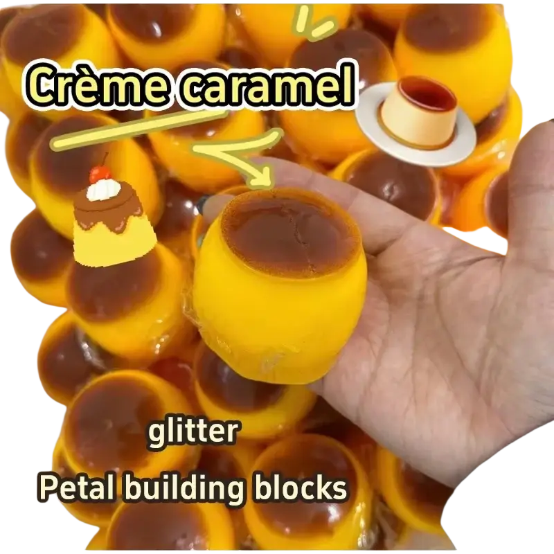 Golden-yellow glossy creme caramel-shaped pudding squishy ASMR stress relief toy with dark brown caramel topping and glittery finish