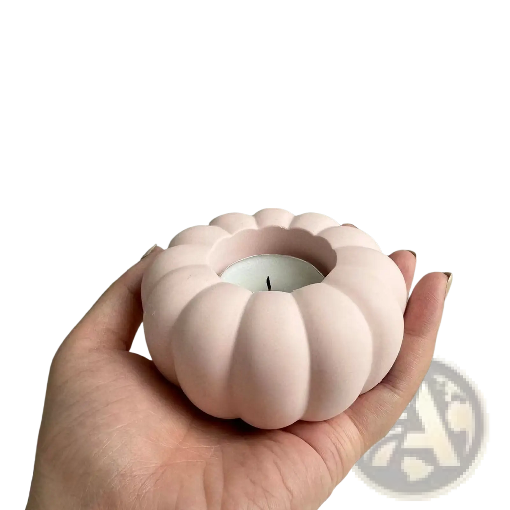 A soft pink ceramic pumpkin-shaped candle holder with smooth matte finish from Pumpkin Candle Holder Silicone Mold T289