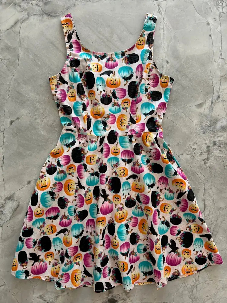 Pumpkin and crow floral halloween skater dress with pockets featuring vibrant orange teal and pink pumpkins with black bats on white