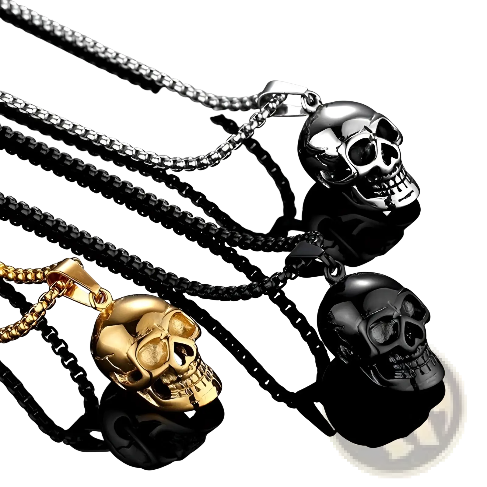 Three skull-shaped punk pendants in silver gold and black titanium steel hang from matching chains on a reflective surface