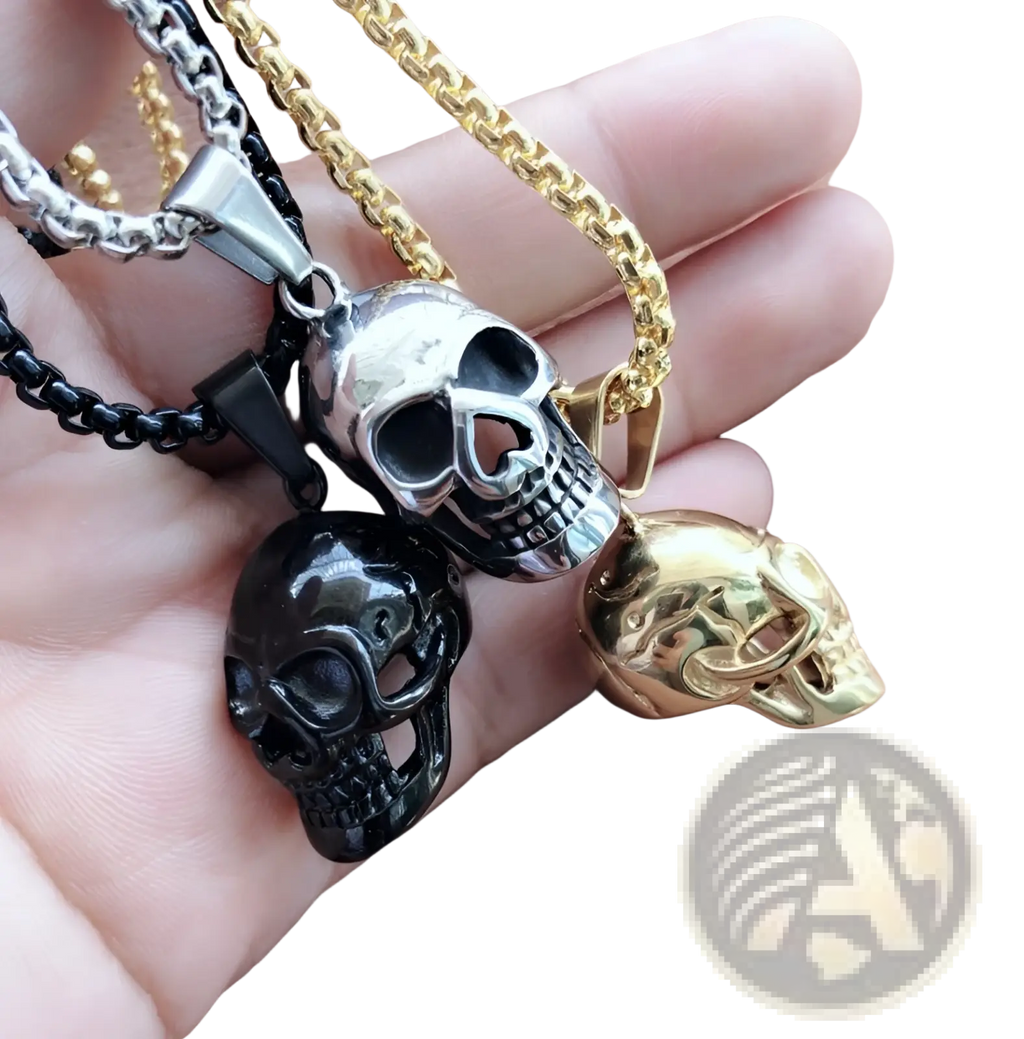 Three skull-shaped pendant necklaces in silver black and gold titanium steel with detailed engravings for men and women