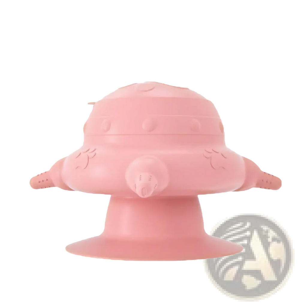 Pink silicone puppy milk feeder shaped like a rounded spaceship with wing-like appendages and a central nozzle