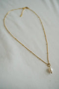 A delicate gold chain necklace with a single white pearl pendant from the Pure Pearl and Gold Bead Layered Necklace Set