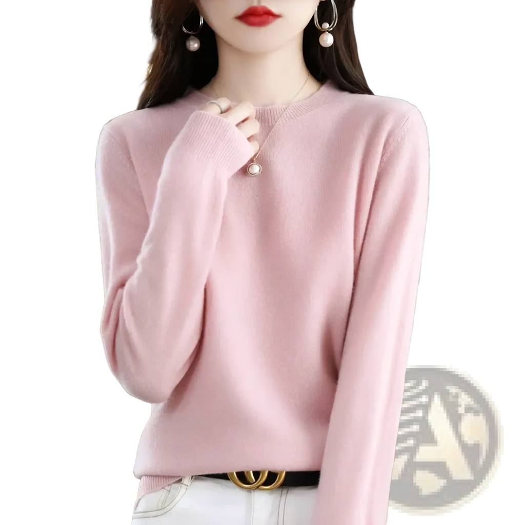 A soft pink pure wool cashmere o-neck sweater for women with long sleeves and ribbed cuffs