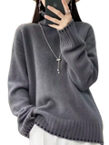 A soft heather gray pure wool turtleneck sweater for women with ribbed cuffs and hem in a loose knit pullover design