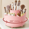 Purple rotating makeup organizer in ribbed pink plastic with multiple compartments holding brushes and lipsticks