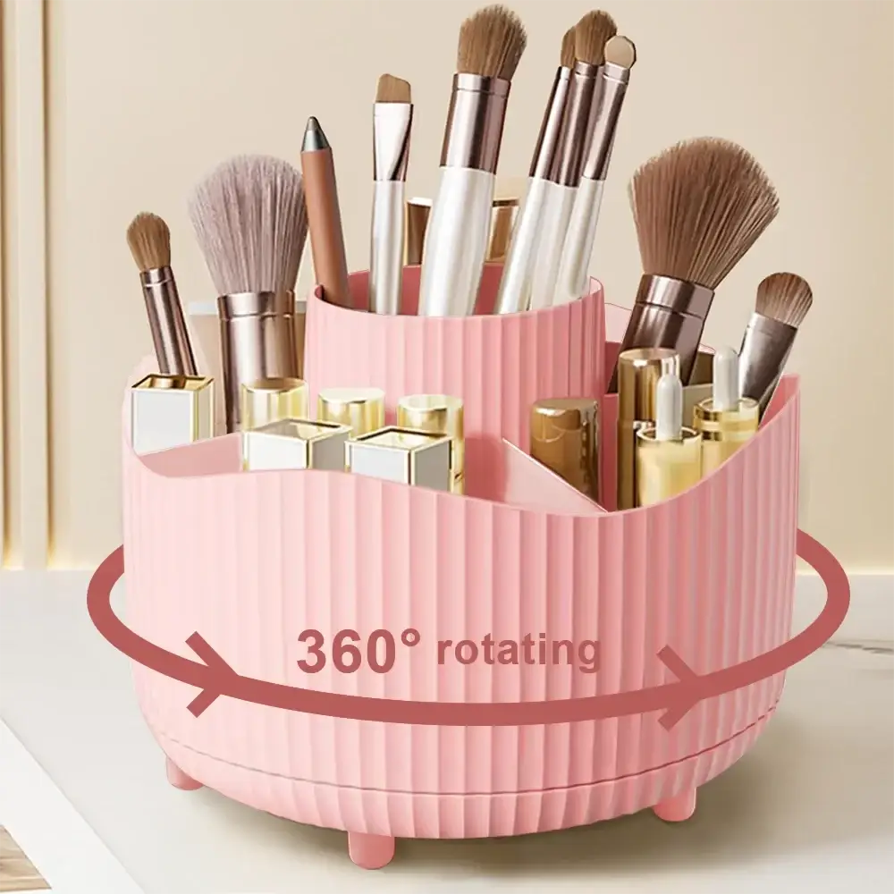 Purple rotating makeup organizer in ribbed pink plastic with multiple compartments holding brushes and lipsticks