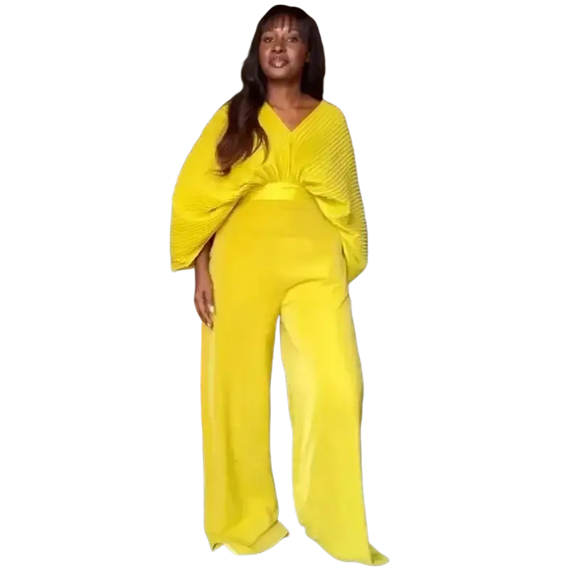 Bright yellow pleated jumpsuit with wide-leg pants and flowing draped top paired with purple satin two piece set wide leg pants