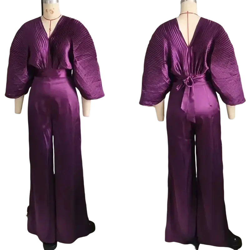 Purple satin two piece set with pleated three quarter sleeve jumpsuit and matching belt tied at the waist